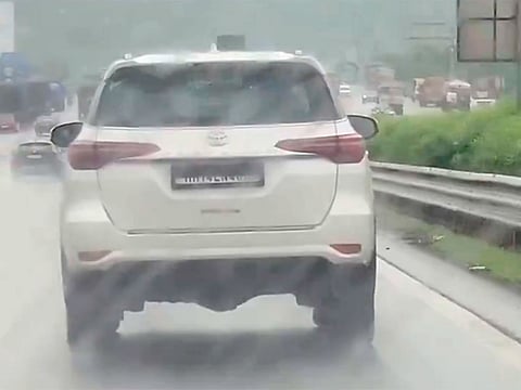 A button inside the vehicle activated a black shutter that moved over the plate, hiding its registration number from view.