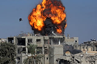 Smoke and fire rise after a house was targeted by an Israeli strike in Khan Yunis, southern Gaza Strip, on September 9.