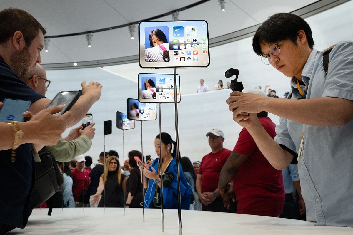 Attendees take photos of the new iPhone Duo during an Apple event at the Steve Jobs Theater in Apple Park in Cupertino, California, on September 9, 2026.