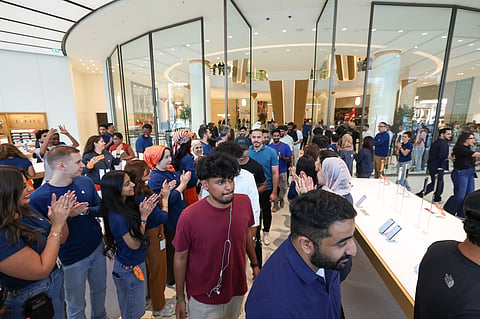 The first set of customers enter the Apple Store at Dubai Mall to buy the new iPhone in 2025.