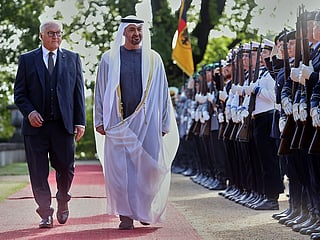 Sheikh Mohammed bin Zayed Al Nahyan, right, and Germany's President Frank-Walter Steinmeier walk past the honour guard in Berlin, Germany.
