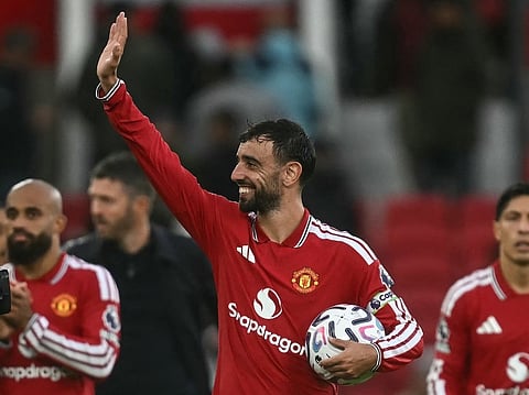 Manchester United's Portuguese midfielder #08 Bruno Fernandes (C) waves at the end of the match after getting a hat-trick during the English Premier League football match between Manchester United and Ipswich Town at Old Trafford in Manchester, north west England, on August 30, 2026.