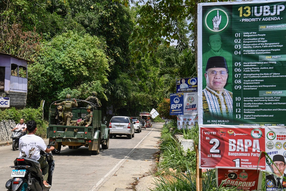 In this photo taken on September 9, 2026, motorists commute past posters of one of the candidates in the Bangsamoro Autonomous Region in Muslim Mindanao (BARMM) election, former Moro Islamic Liberation Front (MILF) chief Murad Ebrahim, in Marawi, Lanao del sur province on the southern island of Mindanao.