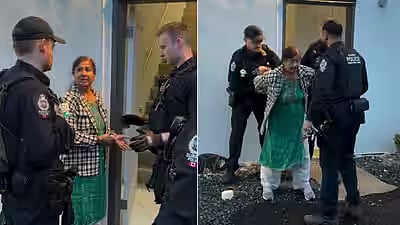 The woman, identified in Indian media reports as Raj Tiwana, was seen being handcuffed by police in Surrey, British Columbia.