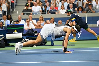 USA's Ben Shelton gets up off the ground after falling during the men's singles final tennis match against Germany's Alexander Zverev on day fifteen of the US Open tennis tournament at the USTA Billie Jean King National Tennis Center in New York City on September 13, 2026.