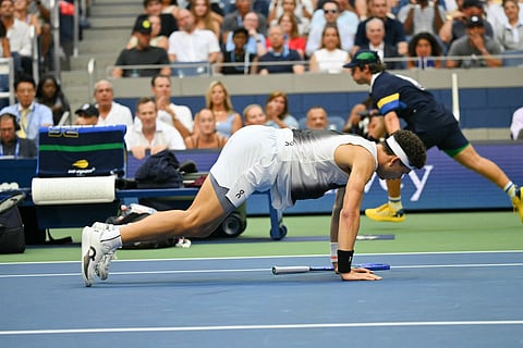 USA's Ben Shelton gets up off the ground after falling during the men's singles final tennis match against Germany's Alexander Zverev on day fifteen of the US Open tennis tournament at the USTA Billie Jean King National Tennis Center in New York City on September 13, 2026.
