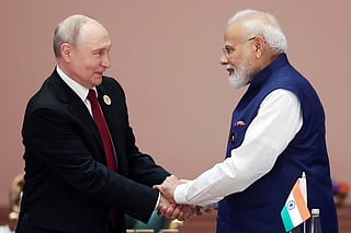 This handout photograph taken on September 13, 2026 and released by the Indian Press Information Bureau (PIB) shows India's Prime Minister Narendra Modi (R) shaking hands with Russia's President Vladimir Putin during the 18th BRICS Summit in New Delhi.