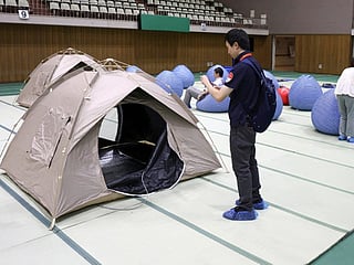 Tents and cushions are seen in a relaxation space set up at the support hub for Japanese team during the 2026 Asian Games, in Nagoya, Aichi prefecture on September 11, 2026.