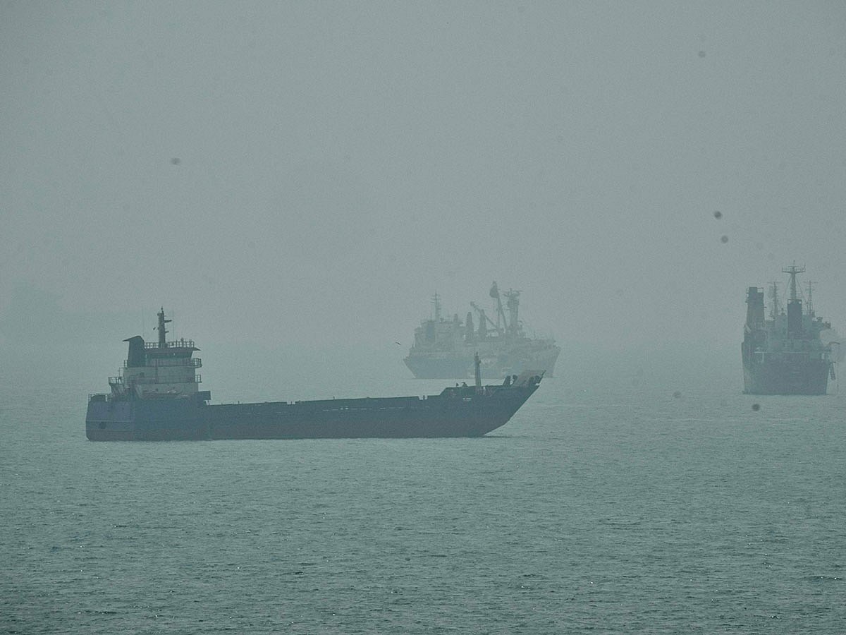 Commercial vessels anchored amid haze in the Strait of Hormuz off Bandar Abbas, Iran