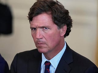 FILE - Tucker Carlson attends a meeting with President Donald Trump and oil executives in the East Room of the White House, Jan. 9, 2026, in Washington.  