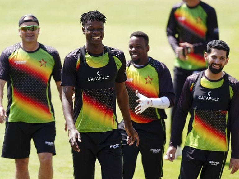 Zimbabwe's Blessing Muzarabani (second from left) and Sikander Raza smile along with teammates in Nottingham.