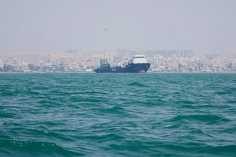 A vessel lies anchored in the Strait of Hormuz off Bandar Abbas, Iran. Commodity-vessel traffic through the strategic waterway fell to just four transits on Monday as regional attacks intensified.