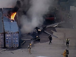 First responders work the scene after a helicopter crashed near a bus crash in Chatsworth, a neighborhood in Los Angeles.