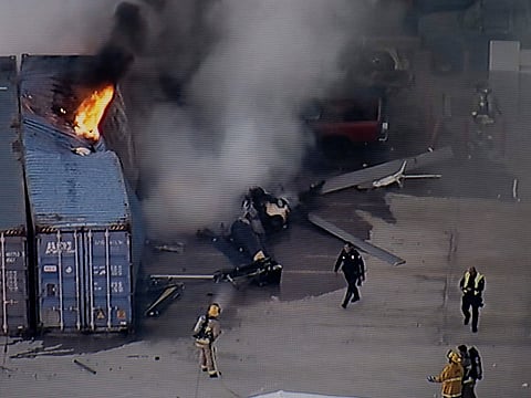 First responders work the scene after a helicopter crashed near a bus crash in Chatsworth, a neighborhood in Los Angeles.