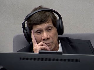 The former president sat with his chin resting on his hands as the proceedings opened.