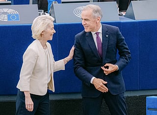This handout photograph taken and released by the European Union on September 16, 2026 shows European Commission President Ursula von der Leyen (L) greeting Canada's Prime Minister Mark Carney during her annual keynote address to the European Parliament in Strasbourg, eastern France.