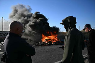 French fishermen make a fire as they block the access of the oil depot of Frontignan, near Sete, south of France, on September 16, 2026 during a a protest aimed at drawing the governments attention to rising fuel prices and the deterioration in their working conditions.  