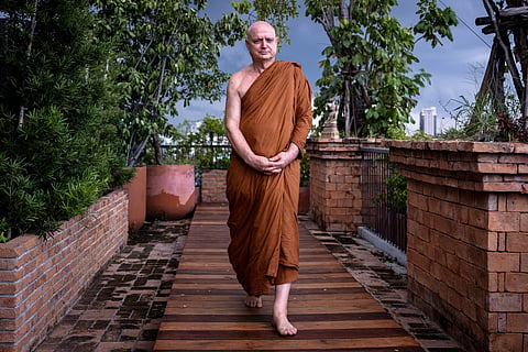 British and Thai Buddhist monk Shaun Chiverton, now known as Ajahn Jayasaro, walks along a meditation path in Bangkok.