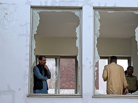 Security personnel stand in a damaged corridor at the site, a day after a fire at the Mother and Child Health ward of the Pakistan Institute of Medical Sciences (PIMS) Hospital in Islamabad on August 27, 2026.