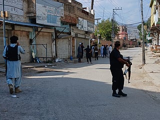 Police officers secure a road leading to the site of a powerful bomb at a mosque in Kohat, Pakistan, Friday, Sept. 18, 2026. 