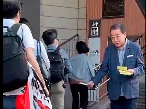 Japan’s ex-PM still hands out flyers after 40 years — and commuters barely notice