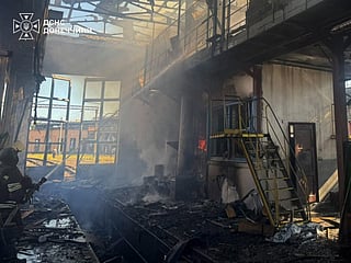 This handout photograph taken and released by the Ukrainian State Emergency Service on September 19, 2026 shows rescuers pushing out a fire in a warehouse damaged following an air strike in Brovary, Kyiv region, amid the Russian attack of Ukraine.