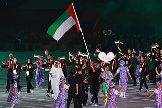 Members of United Arab Emirates' delegation wave their country's national flag during a parade at the opening ceremony of the 2026 Asian Games at Paloma Mizuho Stadium in Nagoya on September 19, 2026.