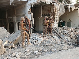 Army personnel stand amid the rubble following an explosion inside the police headquarters at Kohat in Pakistan's Khyber Pakhtunkhwa province on September 18, 2026.