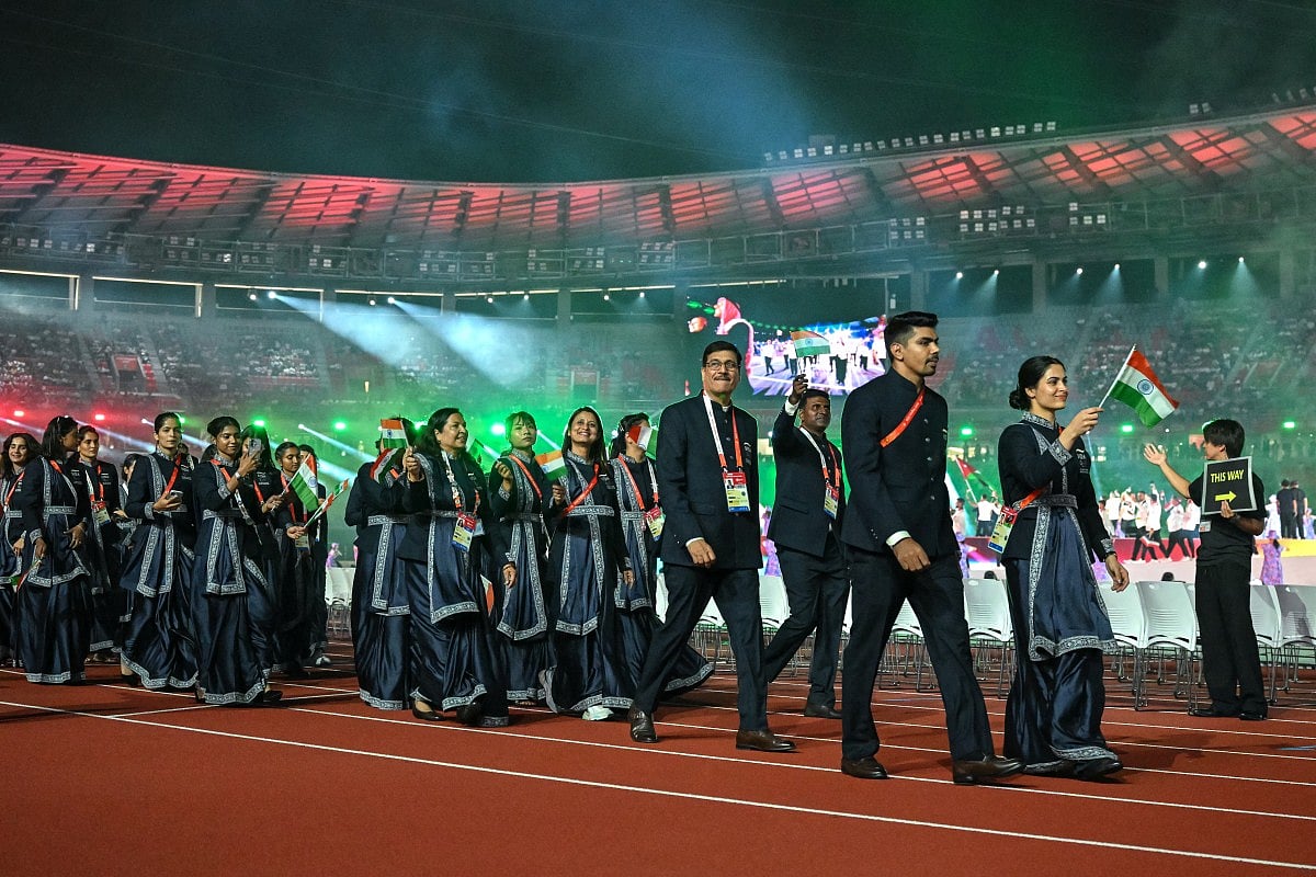Members of India's delegation wave their country's national flag during a parade at the opening ceremony of the 2026 Asian Games at Paloma Mizuho Stadium in Nagoya on September 19, 2026.