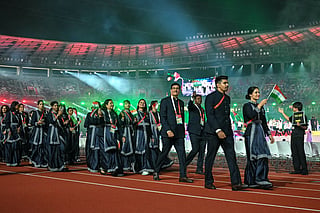 Members of India's delegation wave their country's national flag during a parade at the opening ceremony of the 2026 Asian Games at Paloma Mizuho Stadium in Nagoya on September 19, 2026.