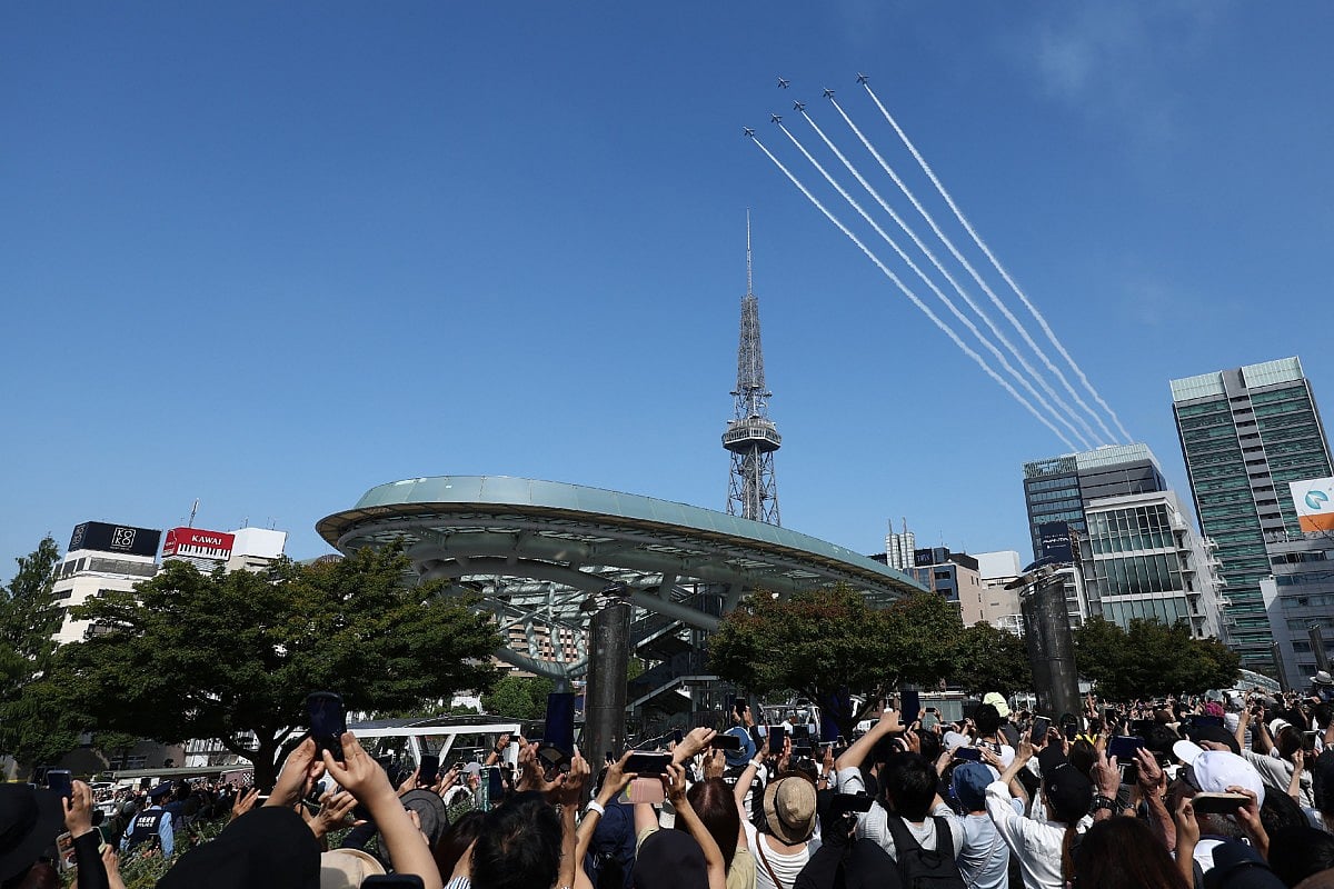 Kawasaki T-4s of the Japan Air Self-Defense Force's Blue Impulse aerobatic demonstration team perform a flypast ahead of the opening ceremony for the 2026 Asian Games in Nagoya on September 19, 2026.