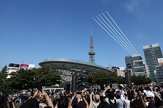 Kawasaki T-4s of the Japan Air Self-Defense Force's Blue Impulse aerobatic demonstration team perform a flypast ahead of the opening ceremony for the 2026 Asian Games in Nagoya on September 19, 2026.