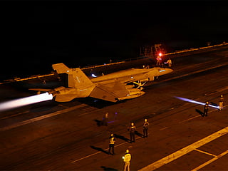 US Sailors conduct night flight operations aboard USS George Washington (CVN 73) as the ship sails in regional waters supporting operations in the Middle East.