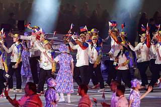 Members of Philippines' delegation wave their country's national flag during a parade at the opening ceremony of the 2026 Asian Games at Paloma Mizuho Stadium in Nagoya on September 19, 2026.