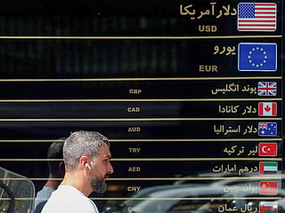 A man walks past a currency exchange along a street in Tehran on September 7, 2026.