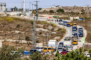 Vehicles queue as Israeli soldiers and police close the Atara checkpoint, north of Ramallah in the Israeli-occupied West Bank