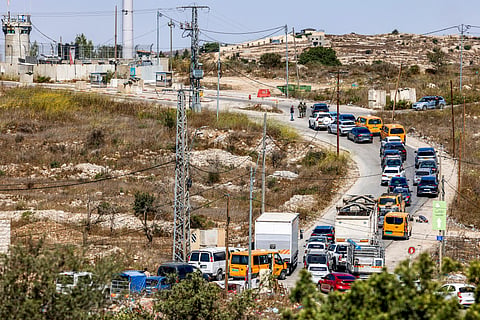 Vehicles queue as Israeli soldiers and police close the Atara checkpoint, north of Ramallah in the Israeli-occupied West Bank