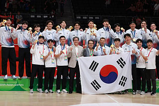 South Korea's team celebrates with their men's basketball gold medals after beating Japan in the final at the 2026 Asian Games at the Aichi International Arena in Nagoya on September 20, 2026.