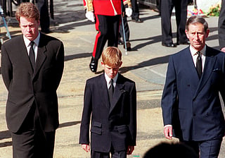 Earl Spencer, Prince Harry and then-Prince Charles join the gun carriage carrying the coffin of the Princess of Wales on Marlboro Road in London during Diana’s funeral on September 6, 1997.  