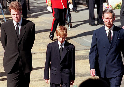 Earl Spencer, Prince Harry and then-Prince Charles join the gun carriage carrying the coffin of the Princess of Wales on Marlboro Road in London during Diana’s funeral on September 6, 1997.  