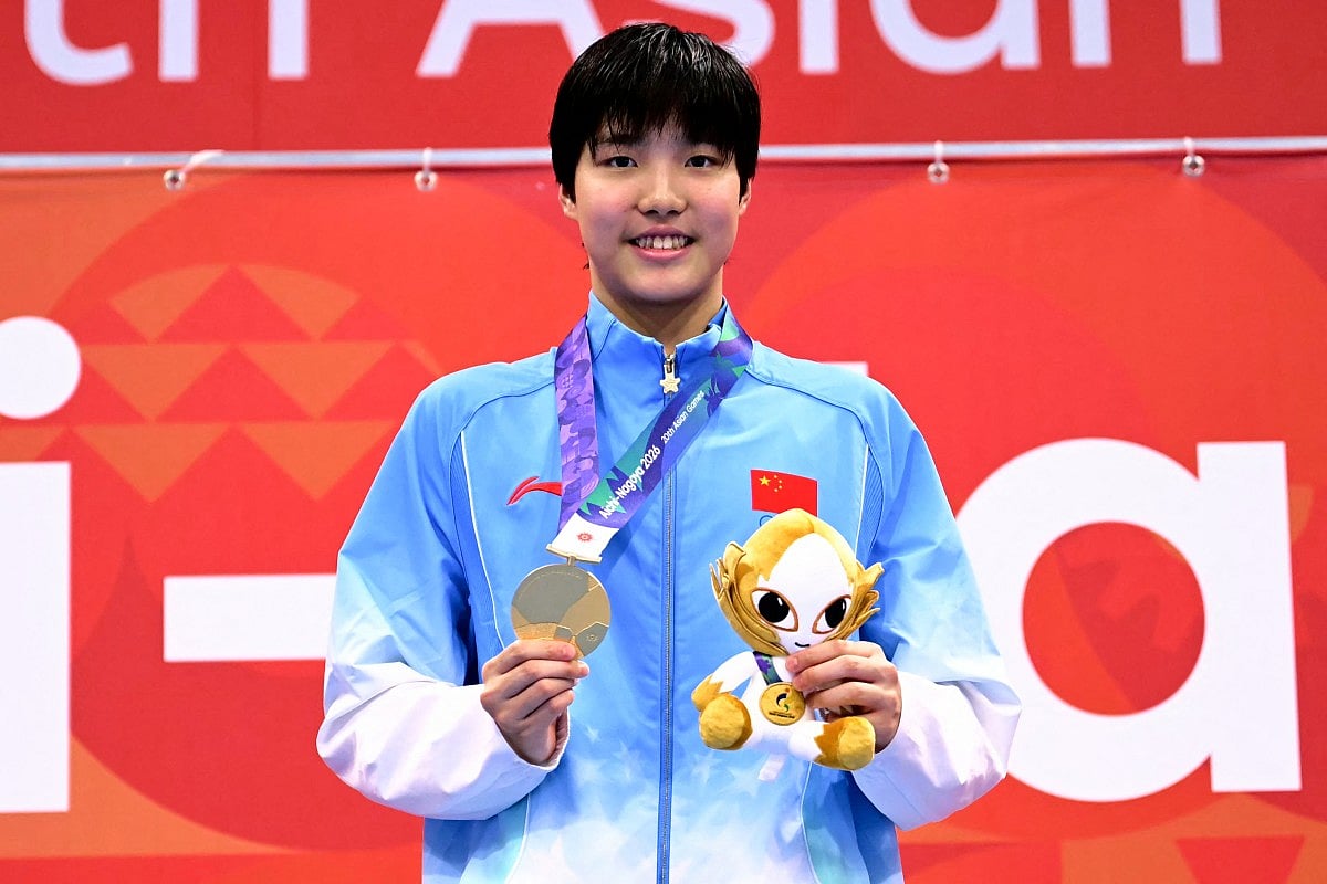 Gold medallist China's Yu Zidi celebrates on the podium during the victory ceremony of the women's 200m butterfly swimming event during the 2026 Asian Games at the Tokyo Aquatics Centre in Tokyo on September 20, 2026.