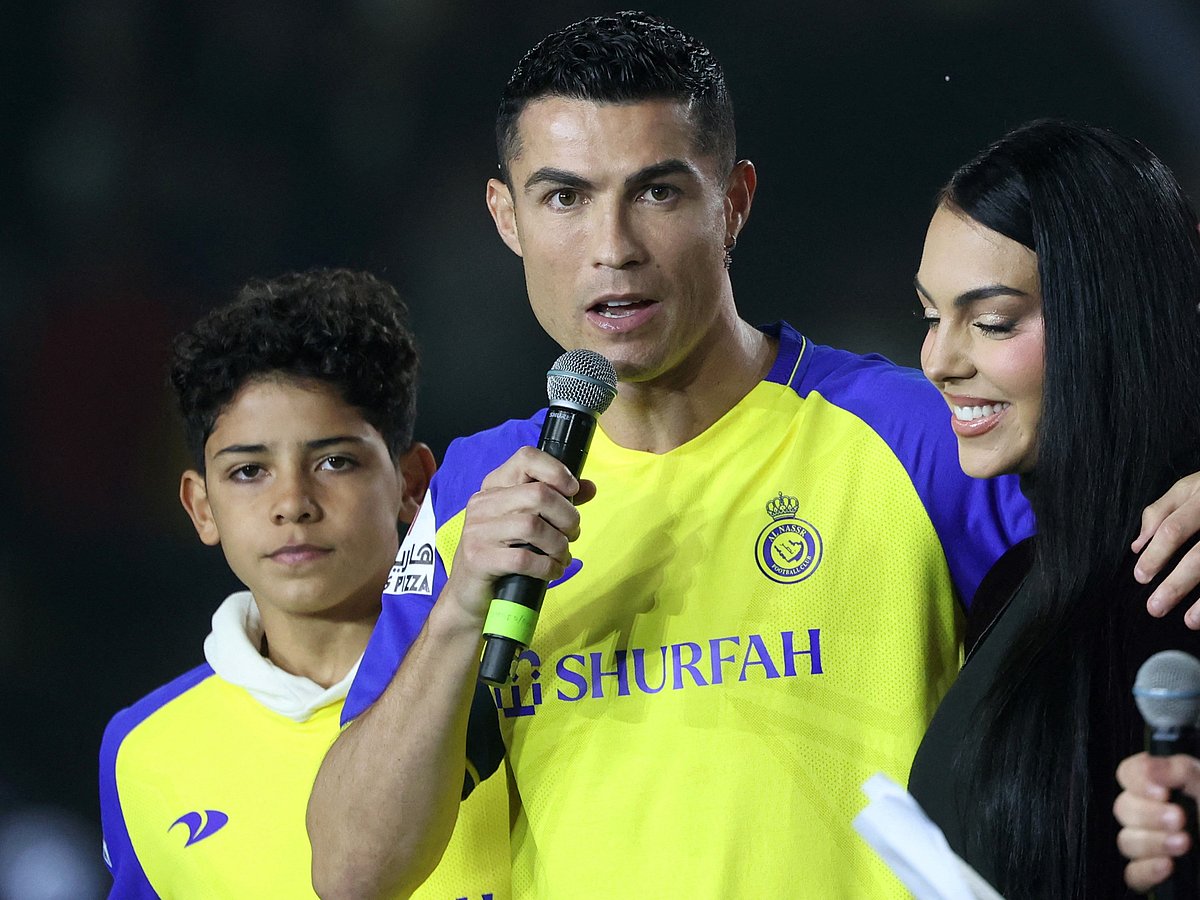 Portuguese forward Cristiano Ronaldo (C-L), accompanied by his partner Georgina Rodriguez (C-R) and his son Cristiano Ronaldo Jr (L), greets the crowd at the Mrsool Park Stadium in the Saudi capital Riyadh