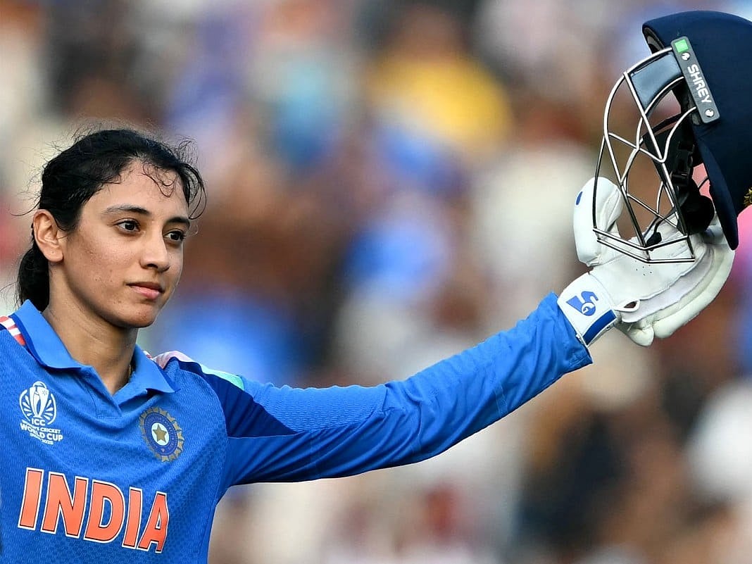 India's Smriti Mandhana celebrates after scoring a century (100 runs) during the ICC Women's Cricket World Cup 2025 one-day international (ODI) match between India and New Zealand at the DY Patil Stadium in Navi Mumbai on October 23, 2025.