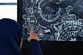 An employee displays a microwave satellite image during a media tour at the facility of Space42, a UAE-based AI-powered SpaceTech company that integrates satellite communications, geospatial analytics and AI capabilities, in Abu Dhabi on September 21, 2026.