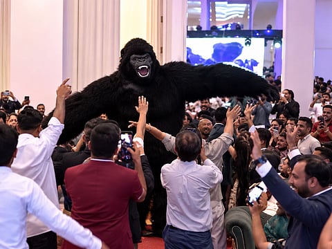 A giant gorilla costume performer dances among guests at a party in Lahore, Pakistan, as the unusual entertainment trend gains attention online.