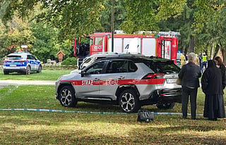 In this handout photograph taken and released by Gazeta Jaroslawska on September 24, 2026, people stand behind police tape at the site of a knife attack in Jaroslaw, eastern Poland.