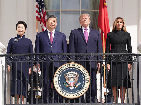 President Donald Trump, center right, first lady Melania Trump, right, China's President Xi Jinping, center left, and his wife Peng Liyuan watch a silent drill platoon review on the new helipad from the Blue Room Balcony of the White House, Thursday, Sept. 24, 2026, in Washington.