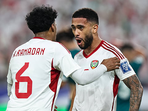 UAE's forward Luan Pereira celebrates with midfielder Abdullah Ramadan after scoring during the FIFA World Cup 2026 Asian qualifier football match