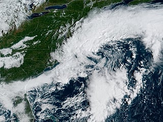 This handout satellite image obtained from the National Oceanic and Atmospheric Administration (NOAA) and their Geostationary Operational Environmental Satellites (GOES) shows a storm system over the Atlantic Ocean along the East Coast of the United States and Canada on September 25, 2026, at 13:26 UTC.