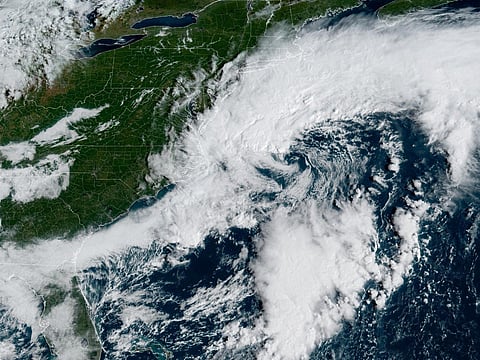 This handout satellite image obtained from the National Oceanic and Atmospheric Administration (NOAA) and their Geostationary Operational Environmental Satellites (GOES) shows a storm system over the Atlantic Ocean along the East Coast of the United States and Canada on September 25, 2026, at 13:26 UTC.